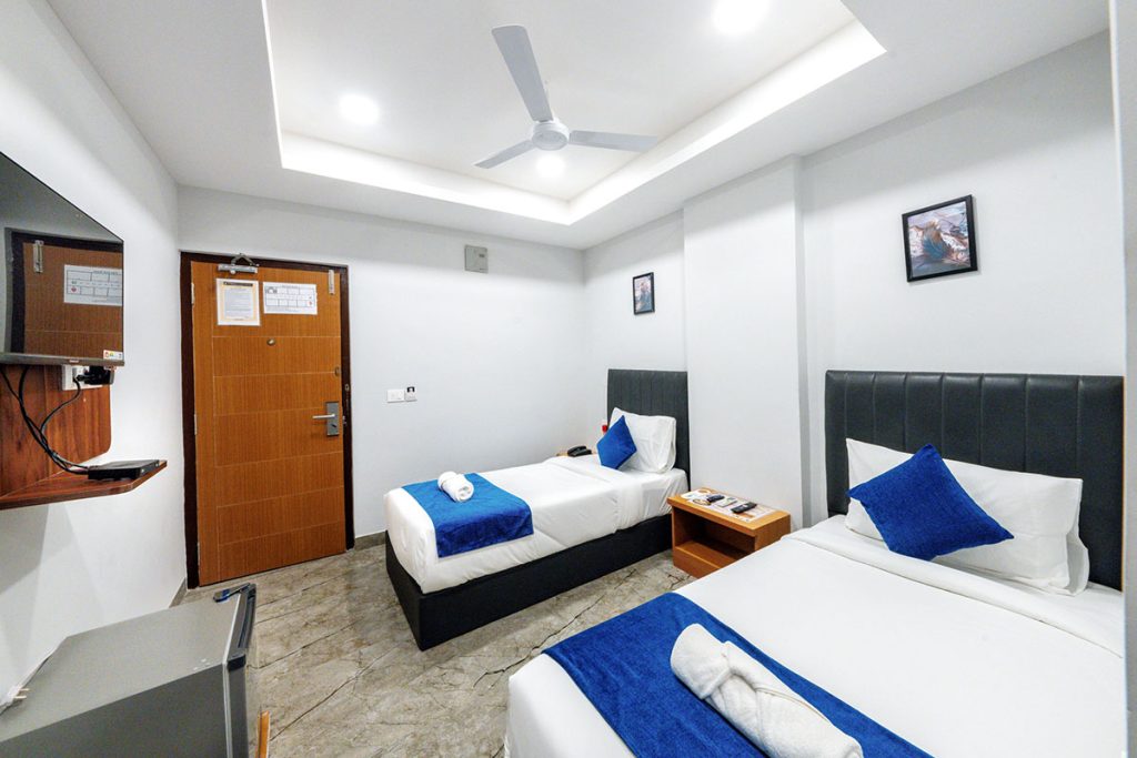 DELUXE TWIN BED TV AND EXIT VIEW